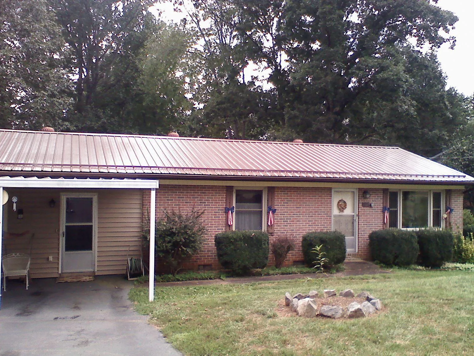 Bronze metal roof and carport on a brick ranch home — Roof Repair work by our crew in Rockland
