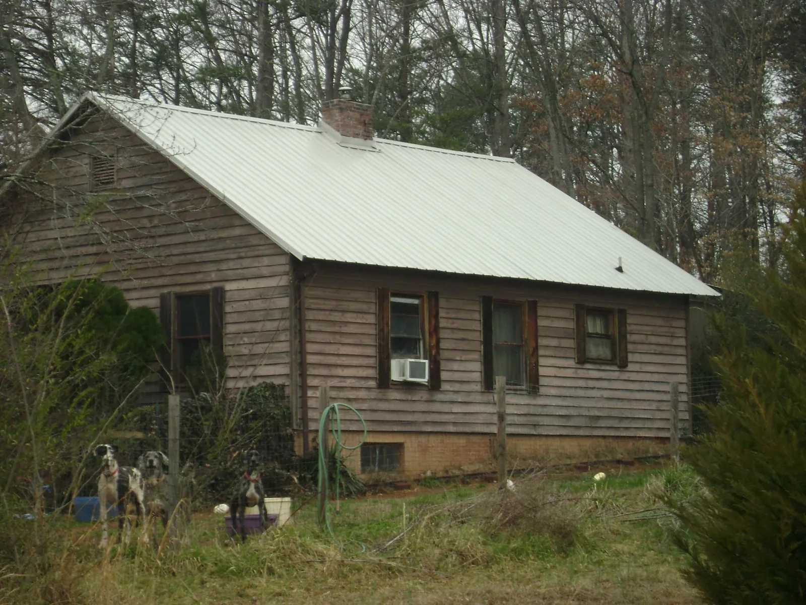 White metal roof on an old wood sided farmhouse, from a Metal Roof Installation job in Rockland